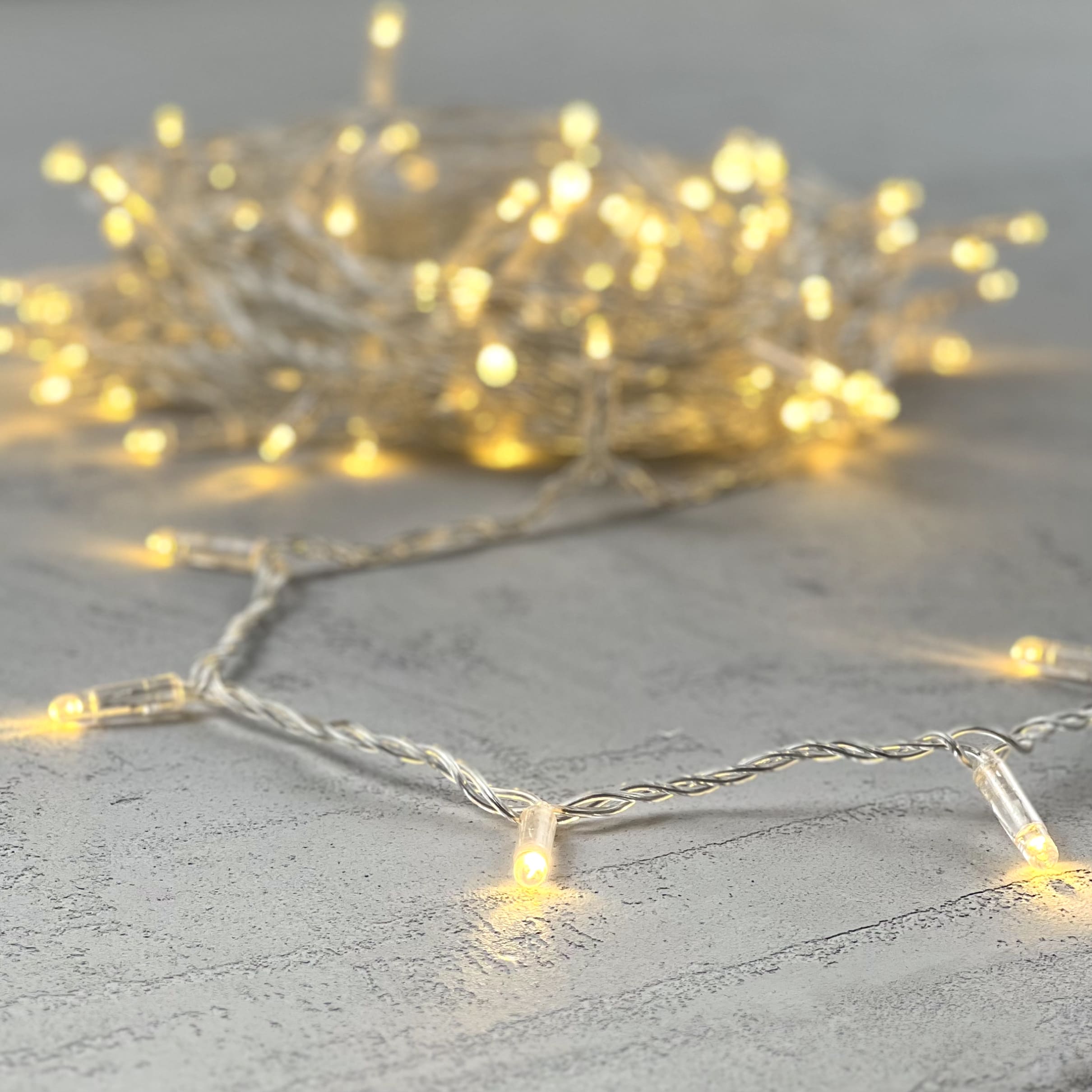 Гирлянда Нить с Колпачком 10м Тепло-Белая 24В, 100 LED, Провод Прозрачный ПВХ, IP65 PST100CAP-10-1WW